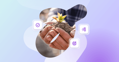 a person is holding a small plant in their hands