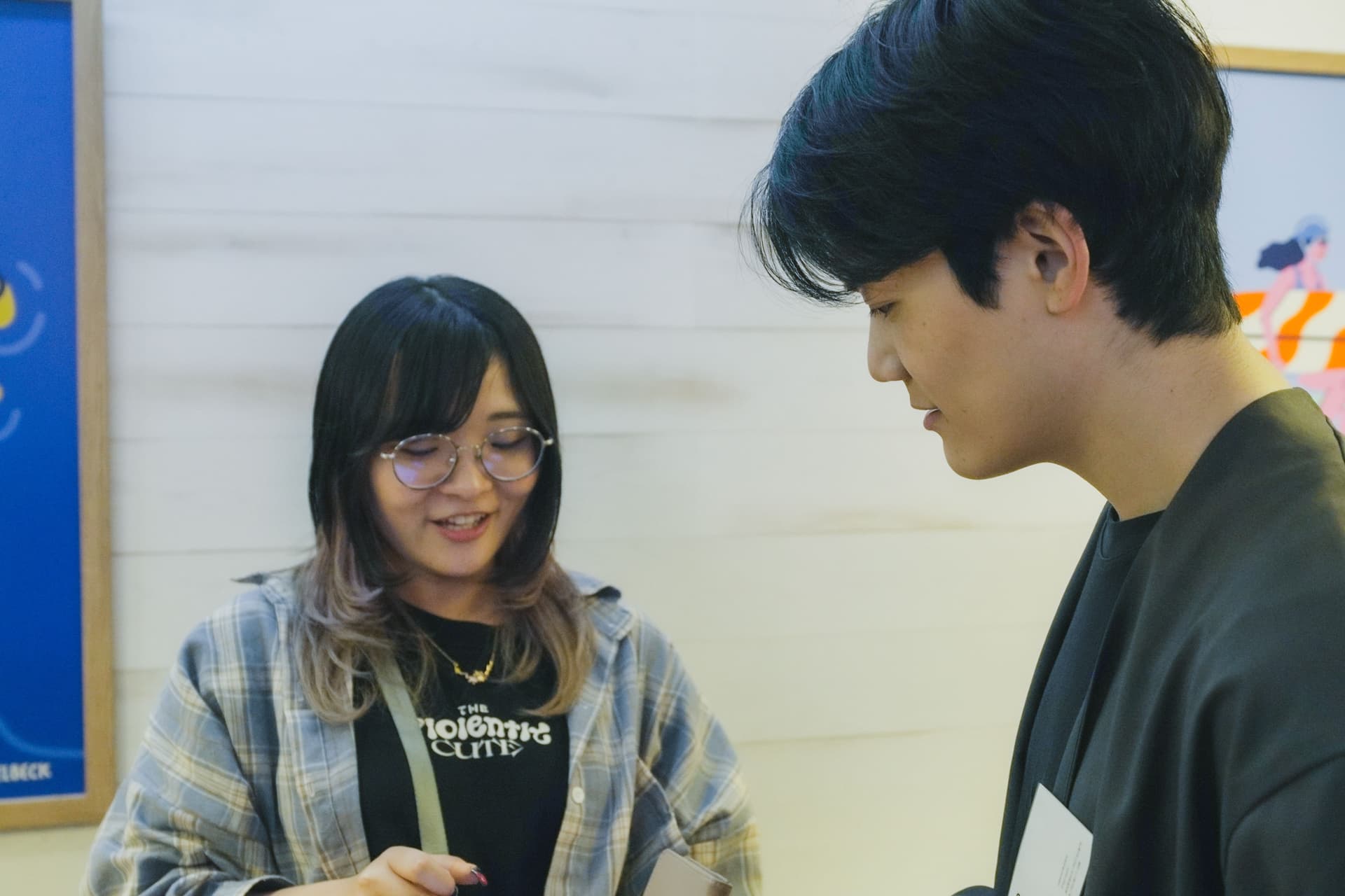 a man and a woman are talking to each other in a room .