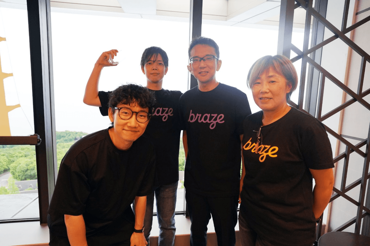 a group of people wearing braze shirts pose for a picture