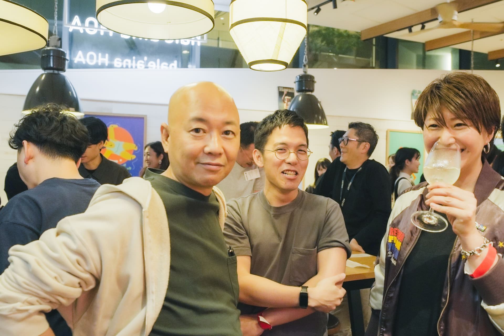 a group of people are standing next to each other in a room .