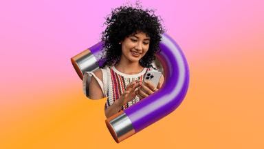 Smiling woman using a smartphone, framed by a purple horseshoe magnet, against a pink and orange background.