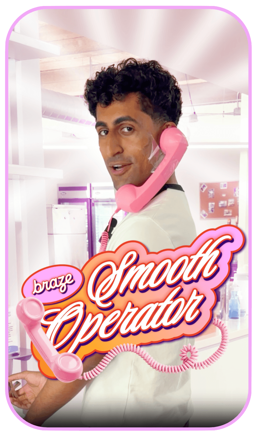 A man with shaving foam on his cheek holds a pink retro telephone to his ear, with "braze Smooth Operator" text in the foreground.