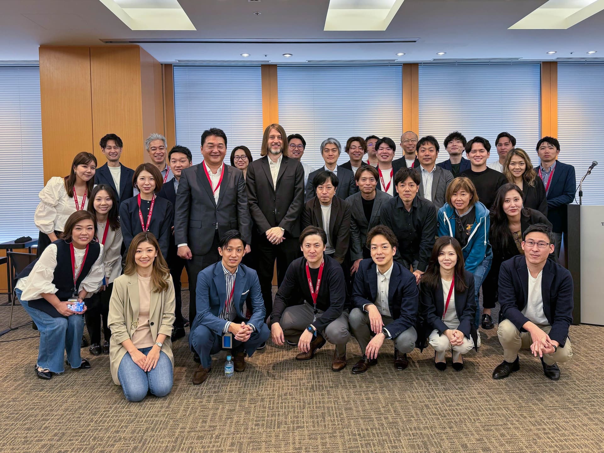 a group of people are posing for a picture in a room .
