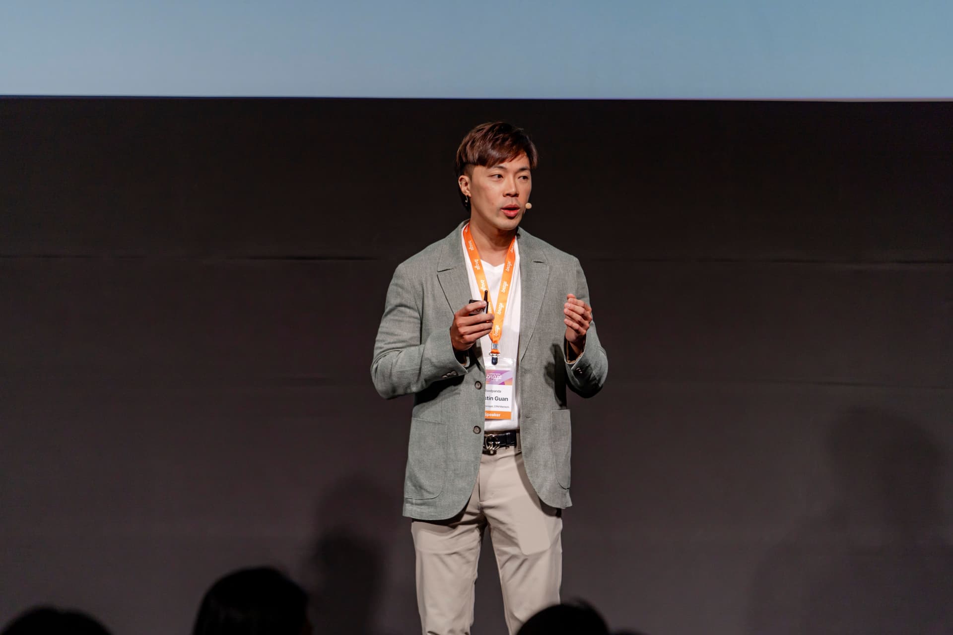 a man in a suit is standing on a stage giving a presentation .