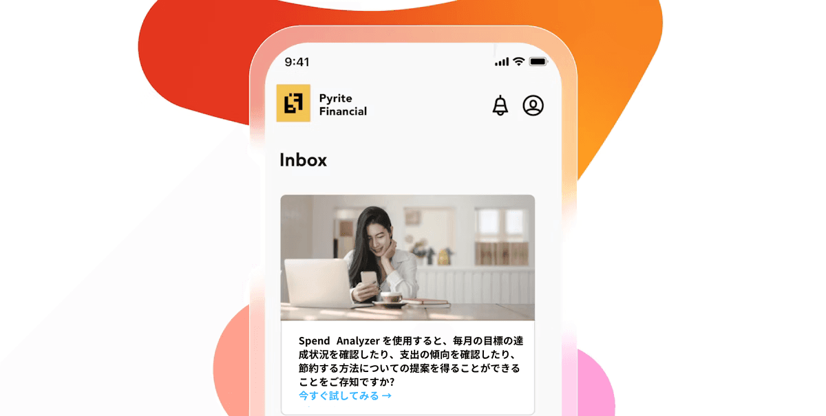 Mobile phone showing Pyrite Financial app inbox with an image of a woman using a phone and laptop, and Japanese text, on a colorful gradient background.