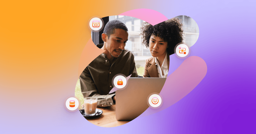 a man and a woman are looking at a laptop together