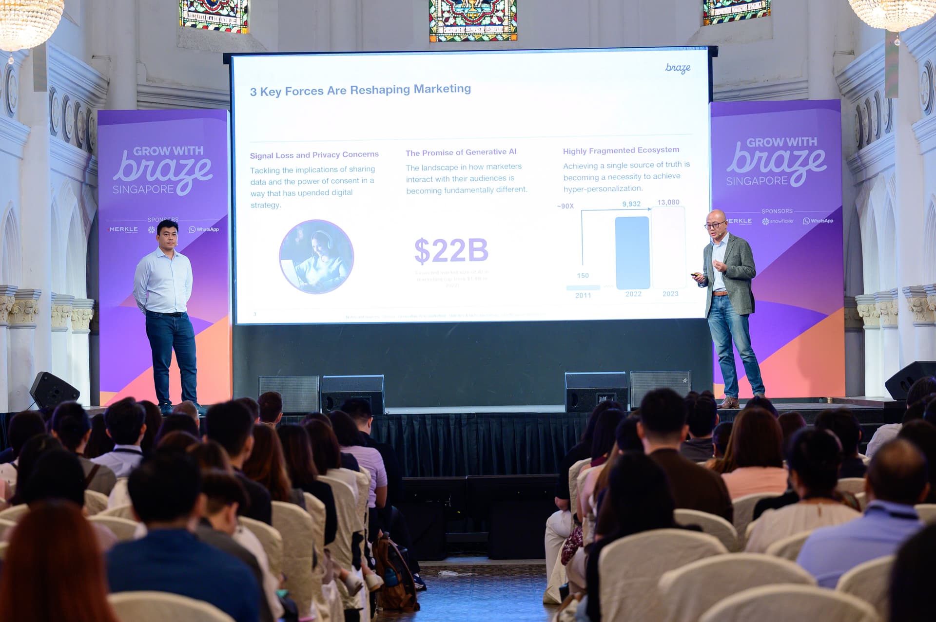 a man is giving a presentation in front of a crowd of people .