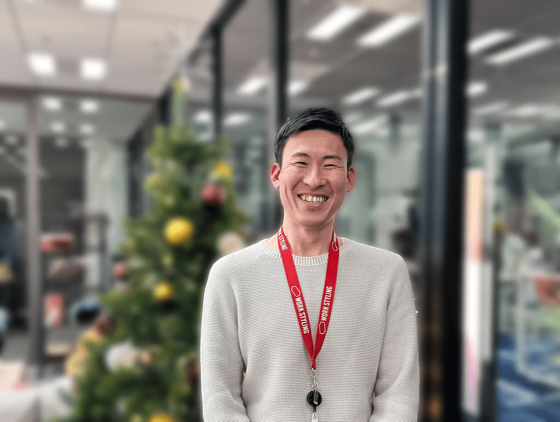 a man with a lanyard around his neck that says smile & styling