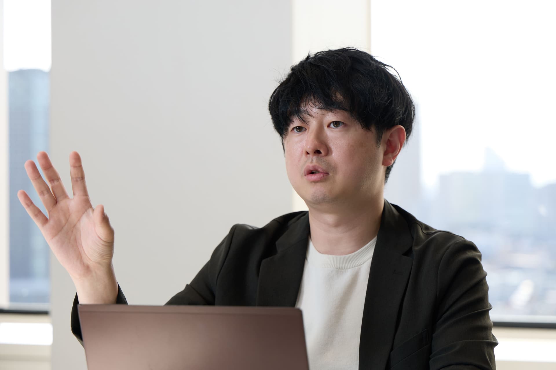マーケティング部長 益嶋 裕氏が右手をあげながら話している様子