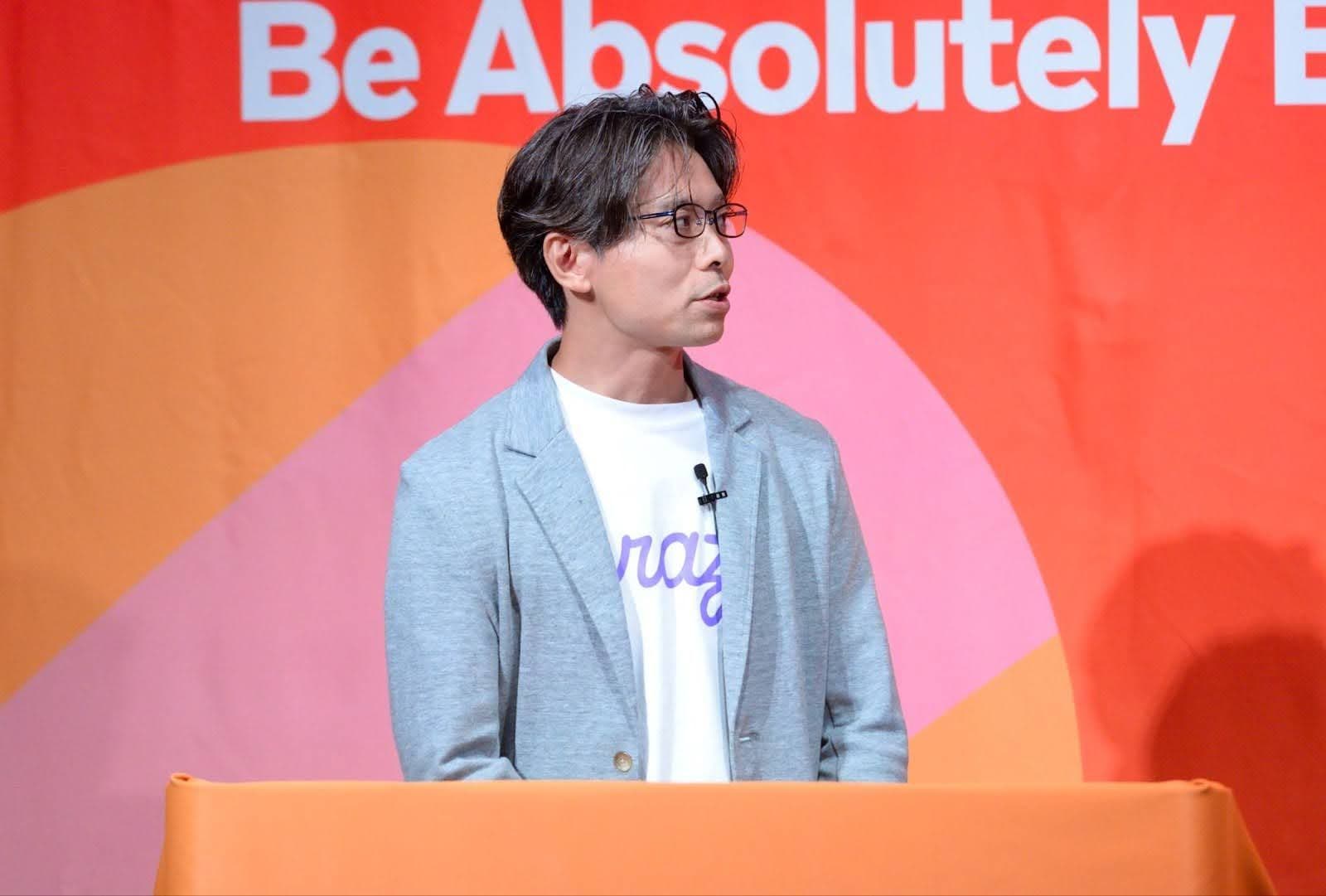 a man is standing at a podium giving a speech .