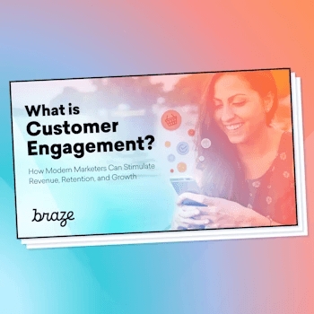 a woman is smiling while looking at her phone with the title what is customer engagement