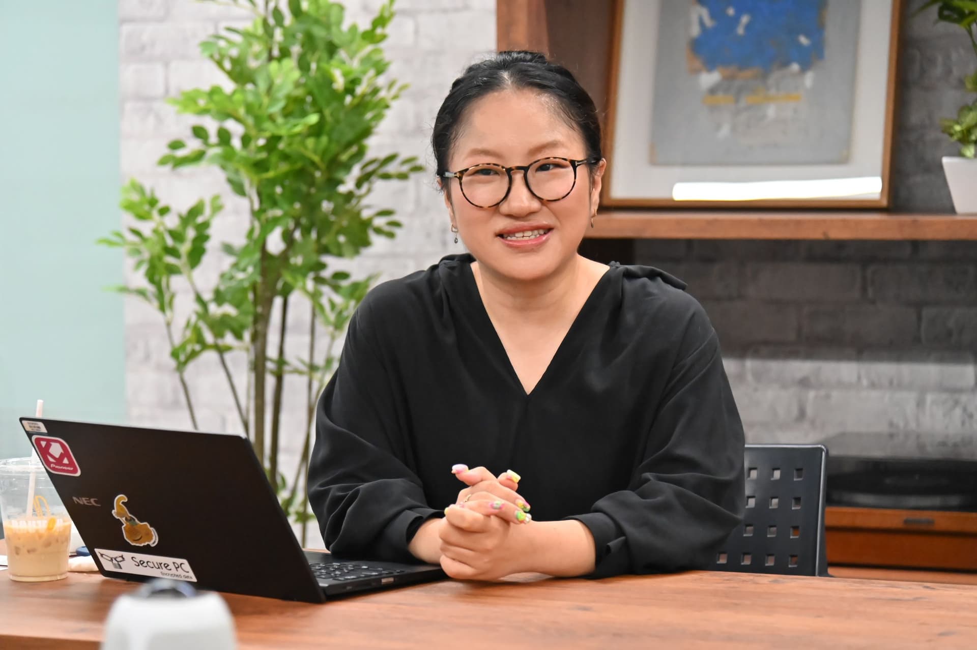 a woman is sitting at a desk with a laptop computer .