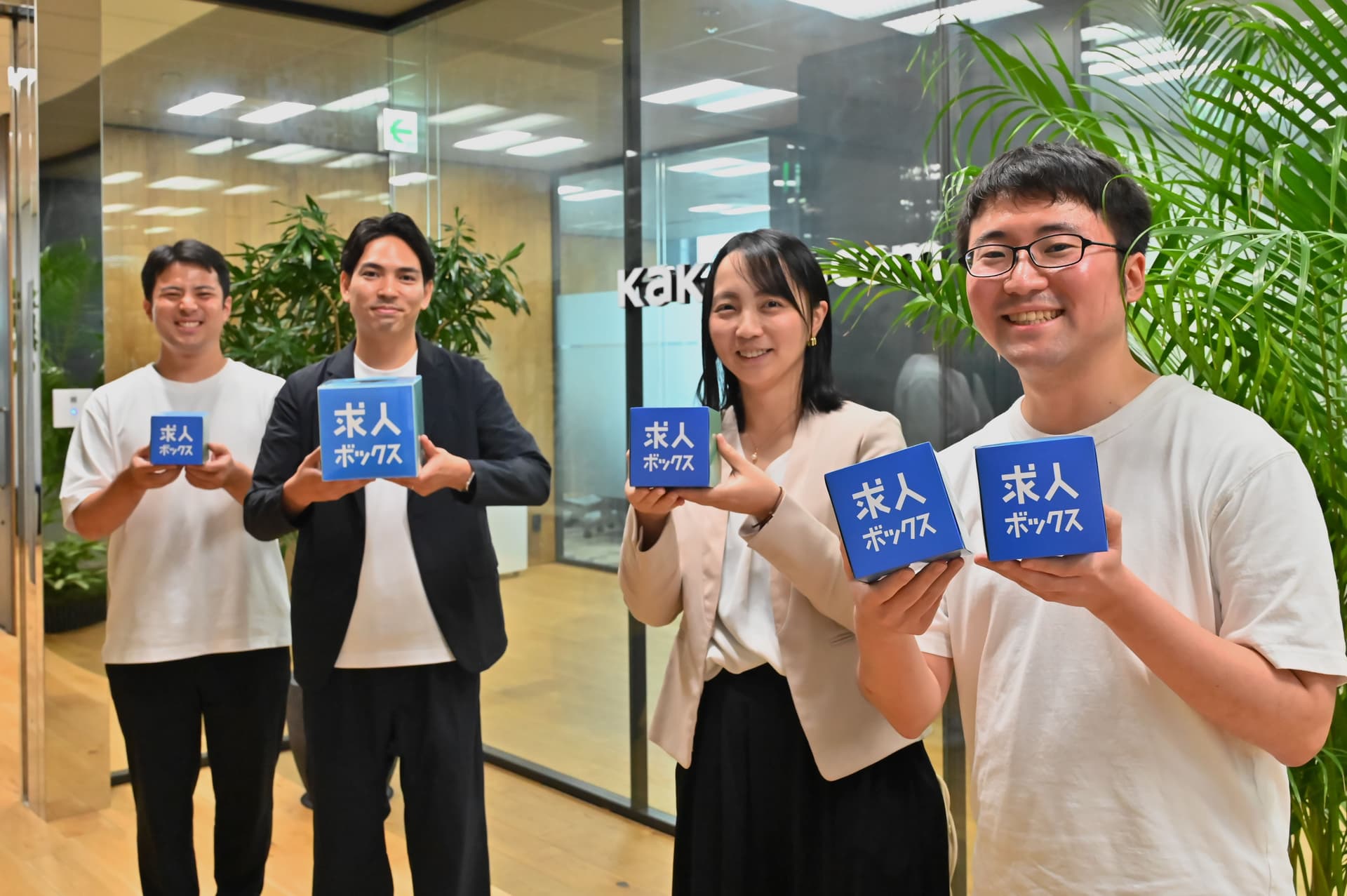 a group of people are standing next to each other holding signs in their hands .