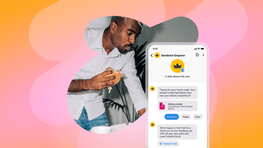 a man eating a sandwich next to a phone that says sandwich emperor