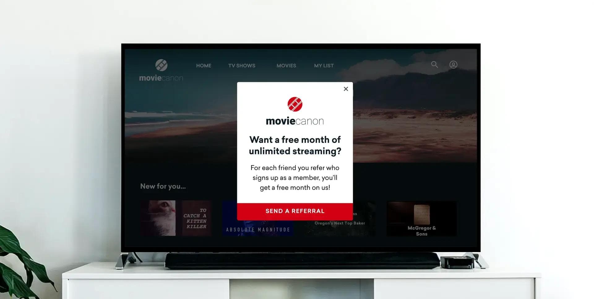 a flat screen tv is sitting on top of a white entertainment center .