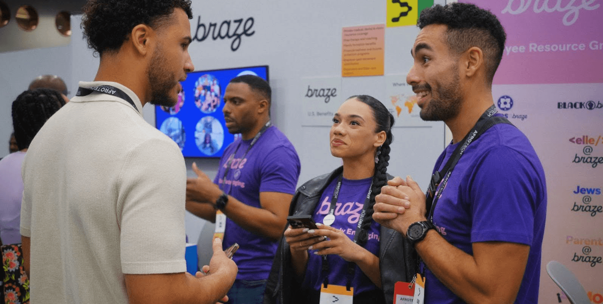 a group of people standing in front of a sign that says braze