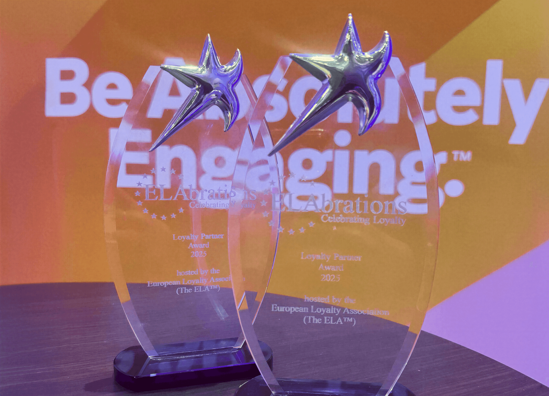 Two clear acrylic awards with silver stars, engraved "Loyalty Partner Award 2023" from the European Loyalty Association.
