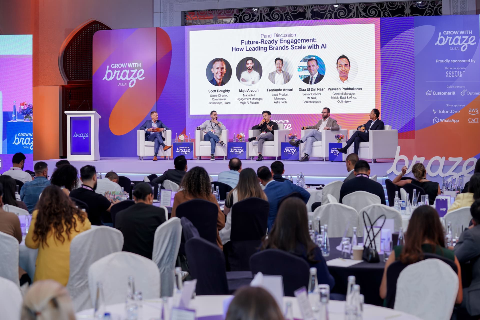 Panel discussion on "Future-Ready Engagement with AI" at the "Grow with Braze" event, with five panelists on stage and an audience.