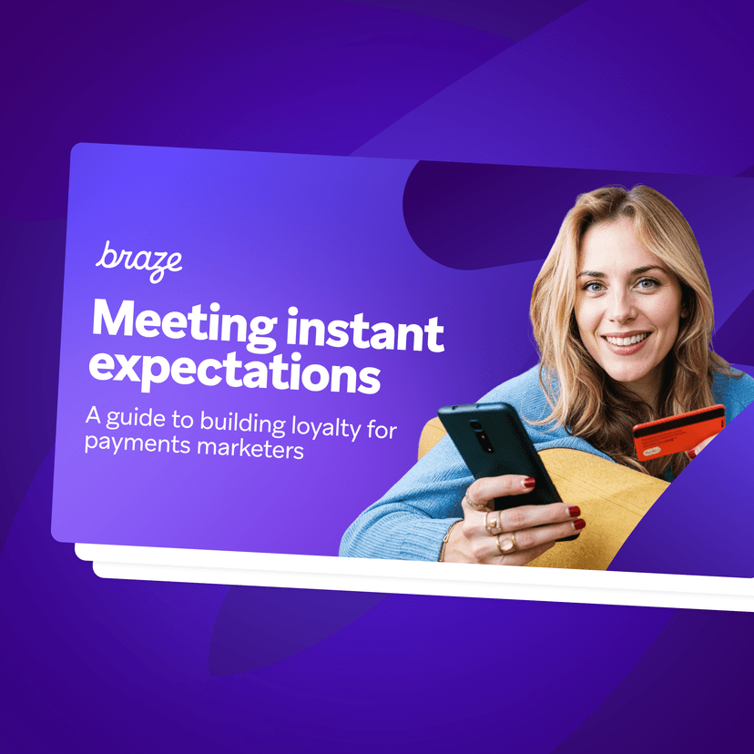 Braze guide: Meeting instant expectations. Smiling woman with phone and credit card.