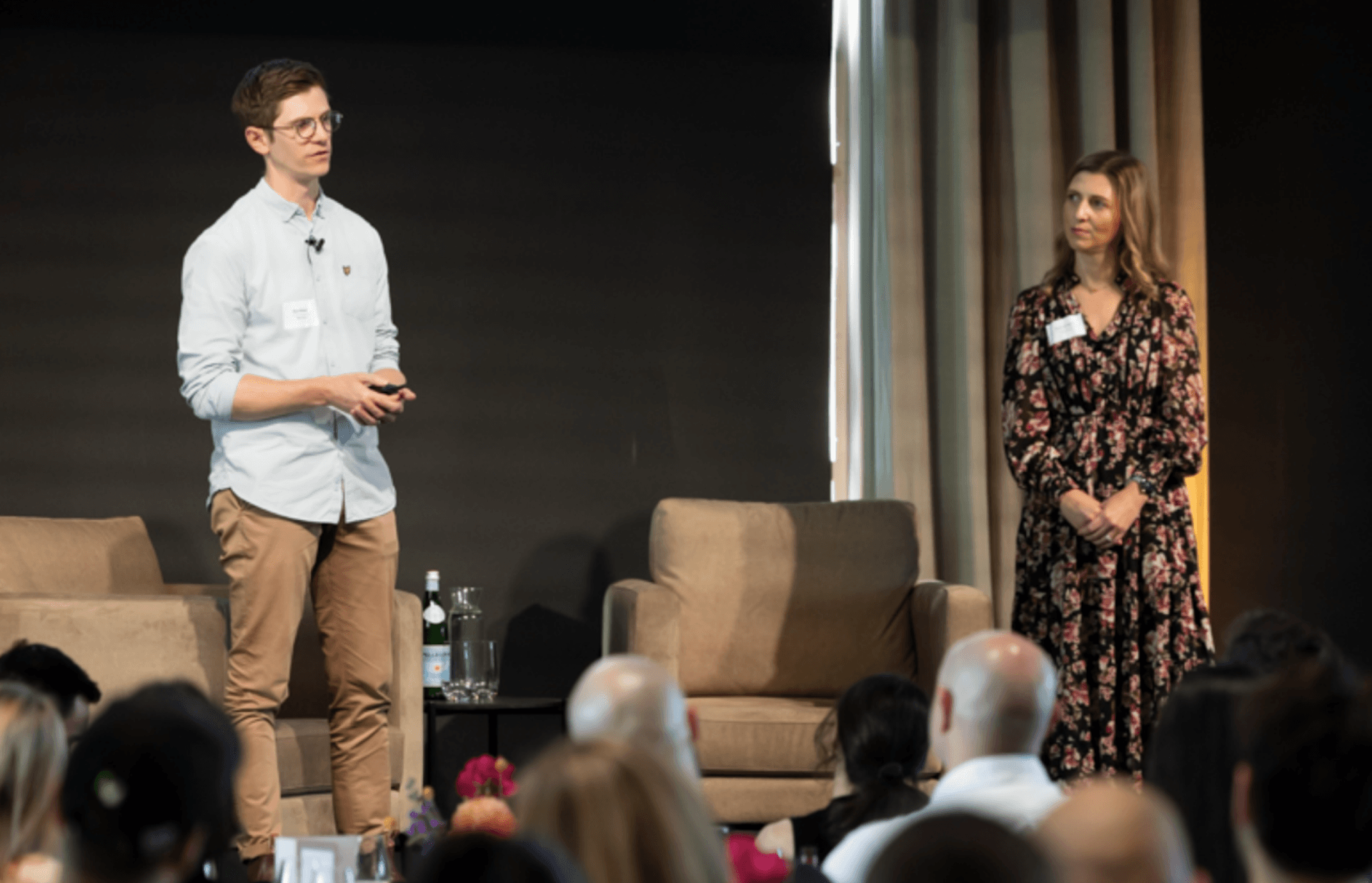 a man and a woman standing in front of a crowd