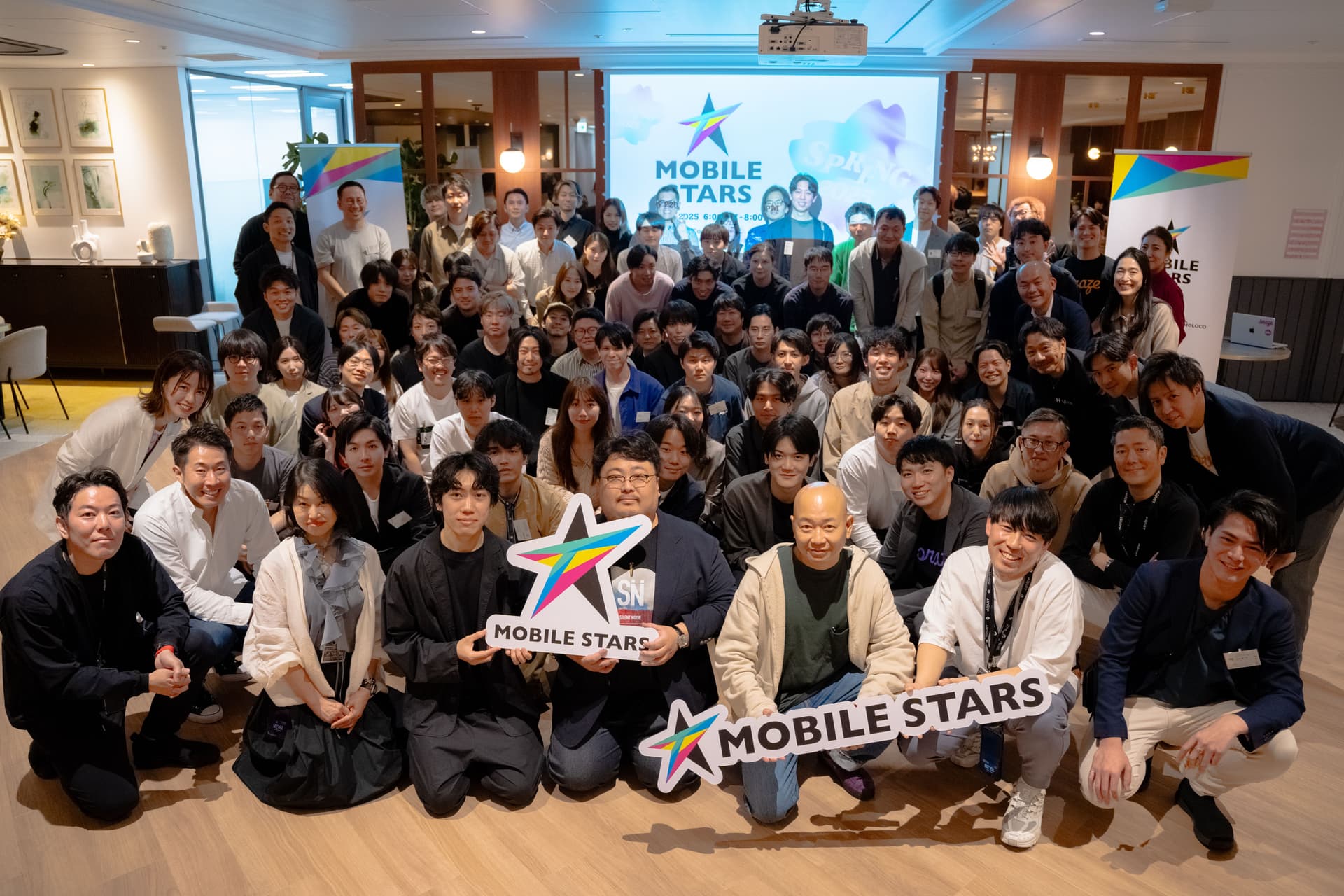 a large group of people are posing for a picture in a room .