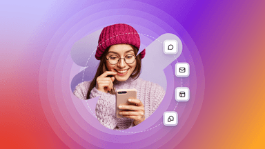 a woman wearing a pink hat and glasses is looking at her phone