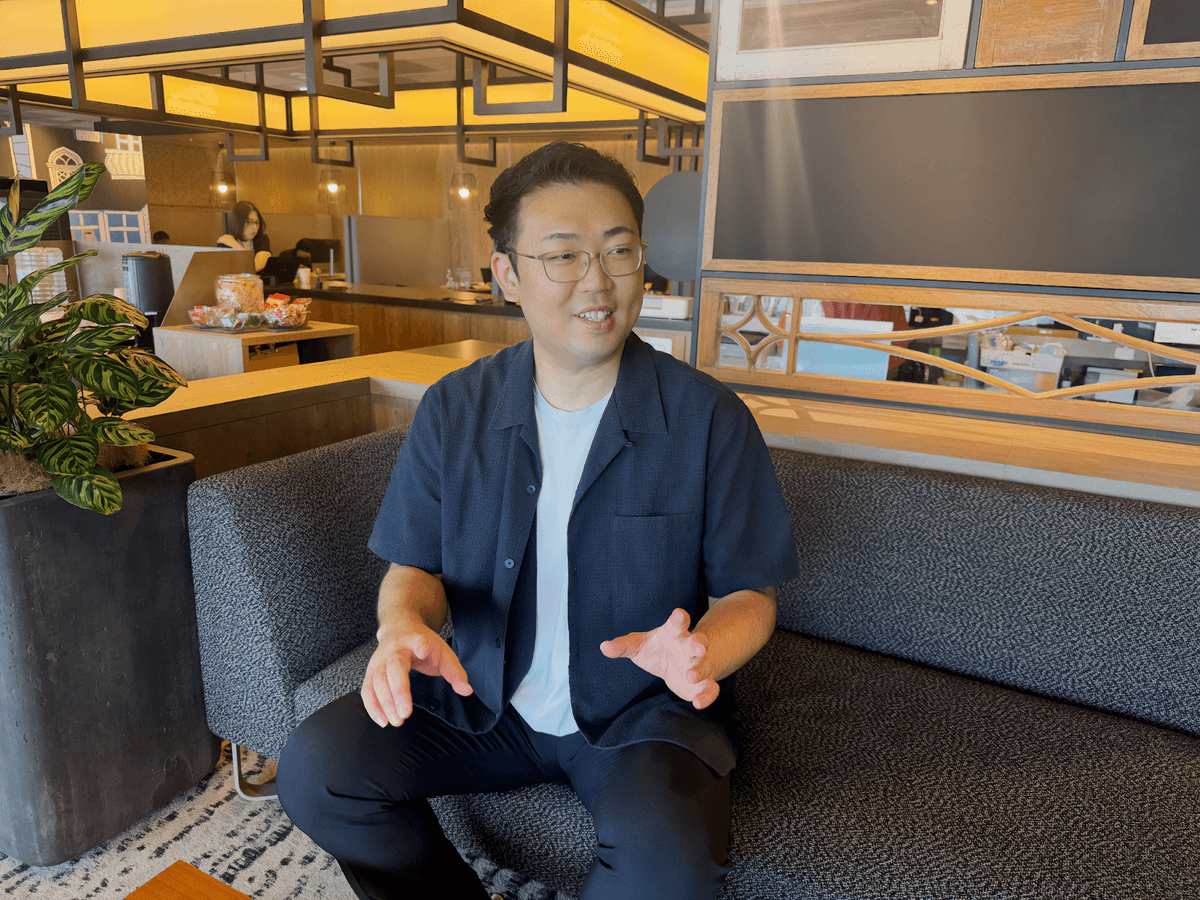 a man sitting on a couch with his hands outstretched