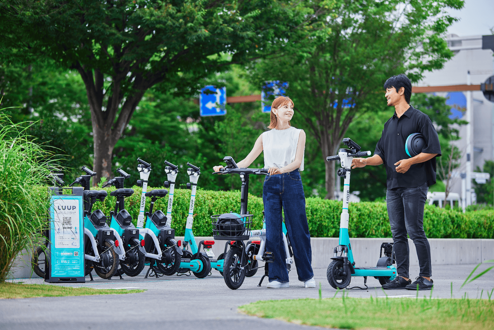 a man and woman are standing in front of a sign that says loup