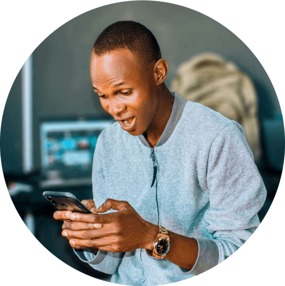 a man wearing a watch is looking at his phone