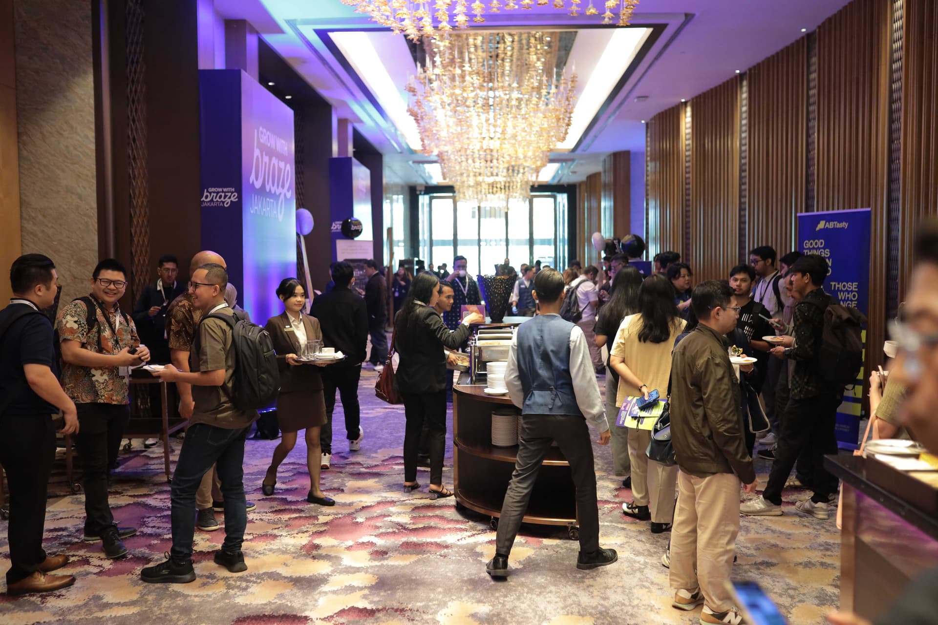 a group of people are standing around a table in a large room .