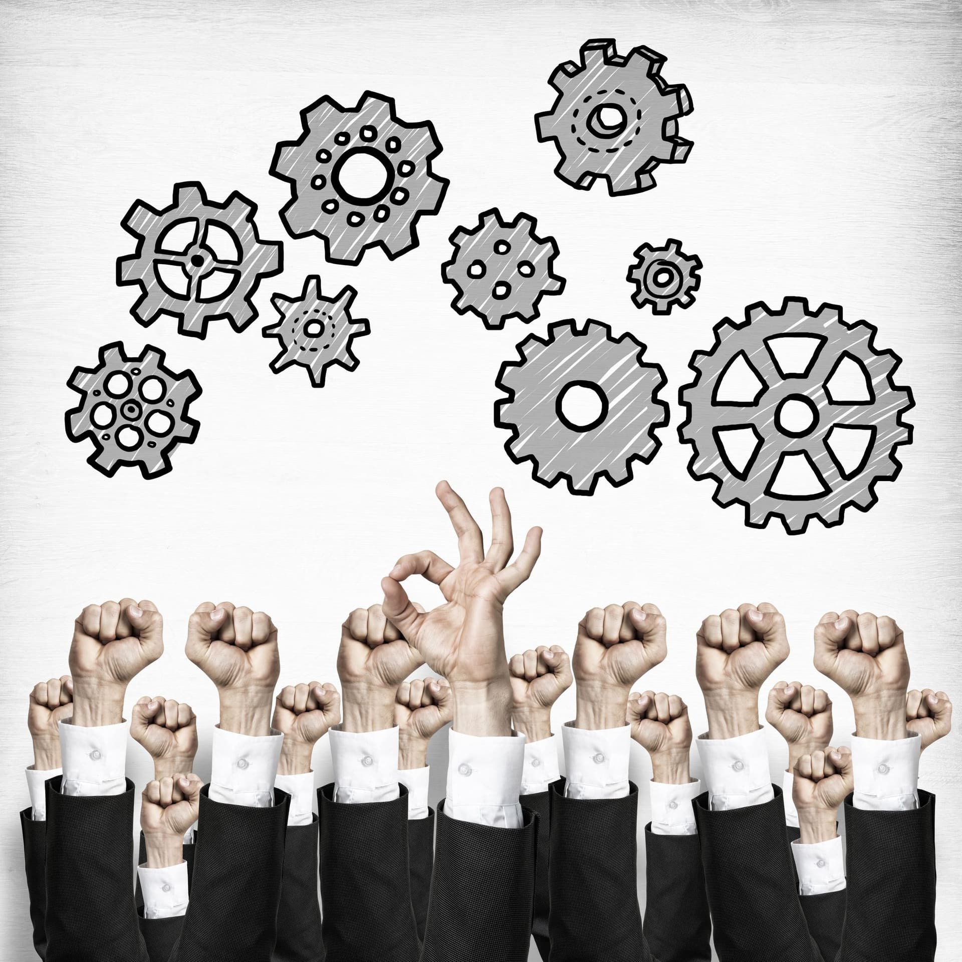 a group of people raising their fists in the air with gears drawn on them