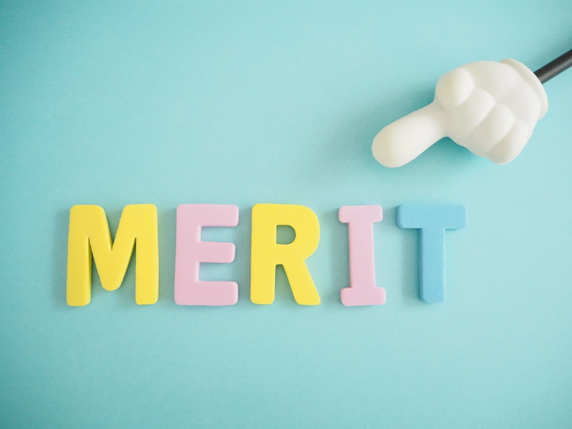 the word merit is made of colorful letters on a blue background .