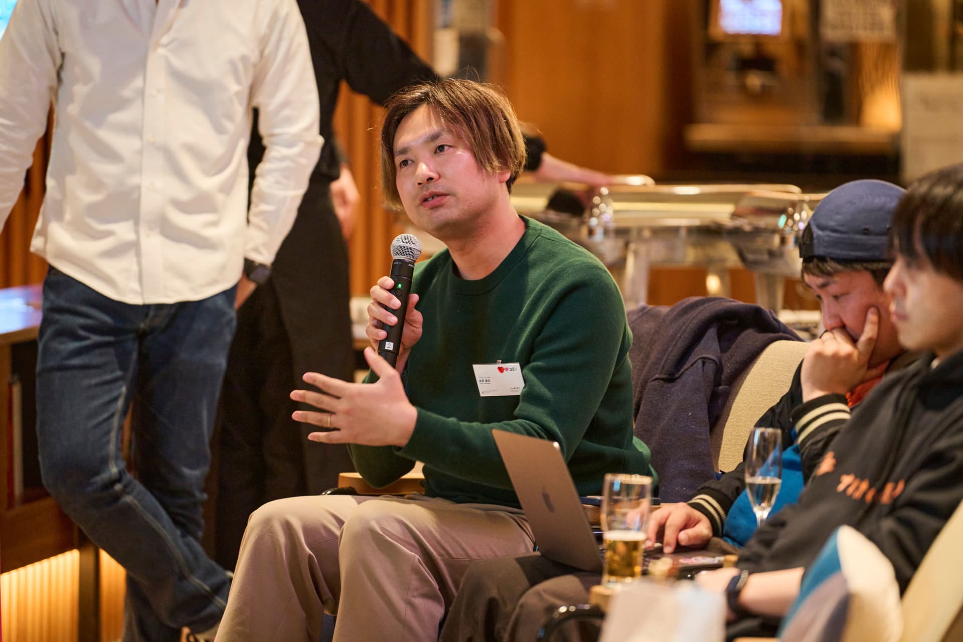a man is sitting in a chair holding a microphone .